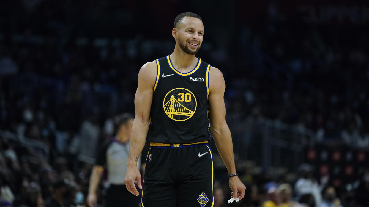 Golden State Warriors guard Stephen Curry (30) smiles during an NBA basketball game against the Los Angeles Clippers in Los Angeles, Sunday, Nov. 28, 2021. (AP Photo/Ashley Landis)