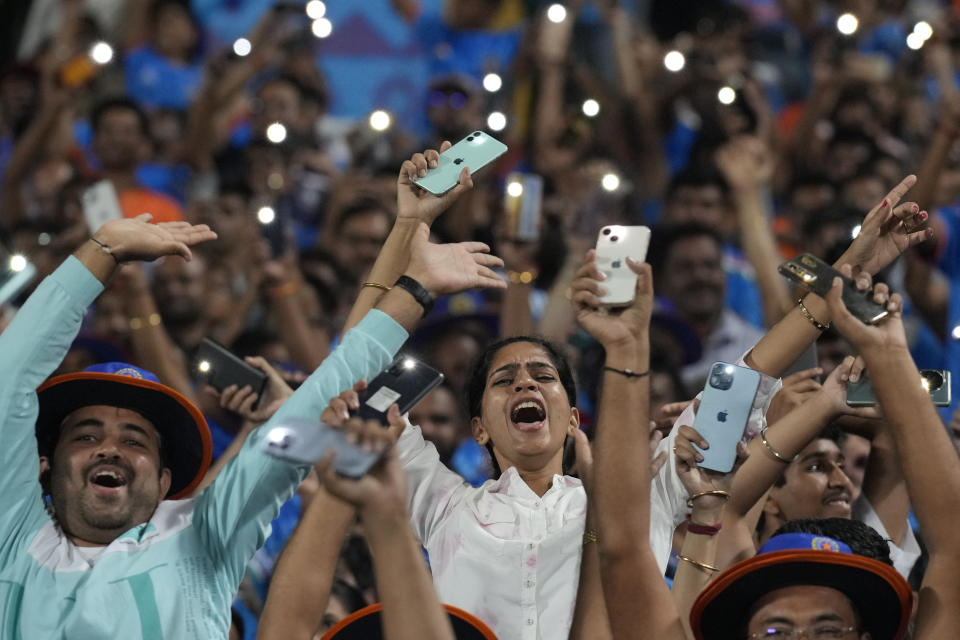 Indian cricket fans cheer during the ICC Men's Cricket World Cup match between India and Bangladesh in Pune, India, Thursday, Oct. 19, 2023. (AP Photo/Anupam Nath)