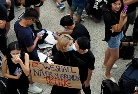 Anti-extradition bill demonstrators attend a protest at the arrival hall of Hong Kong Airport