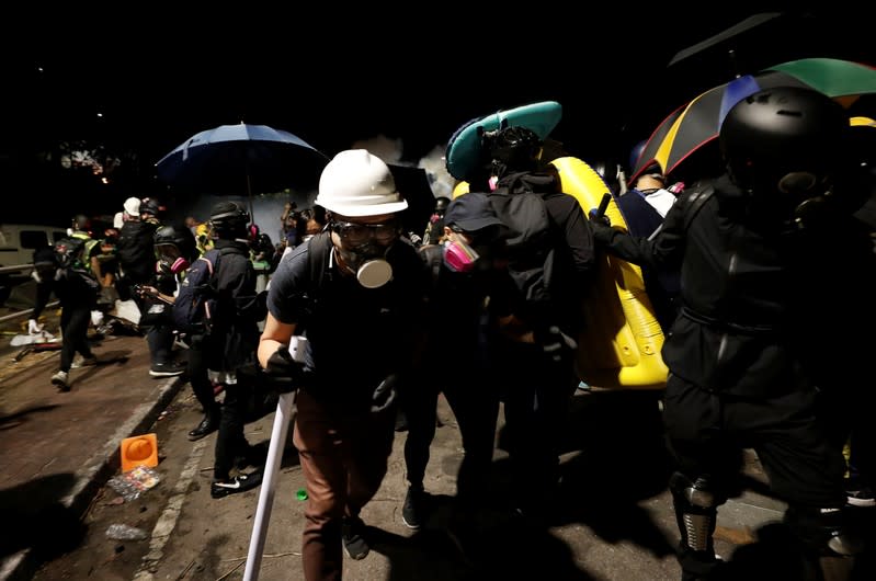 Protesters run during a standoff with riot police at the Chinese University of Hong Kong