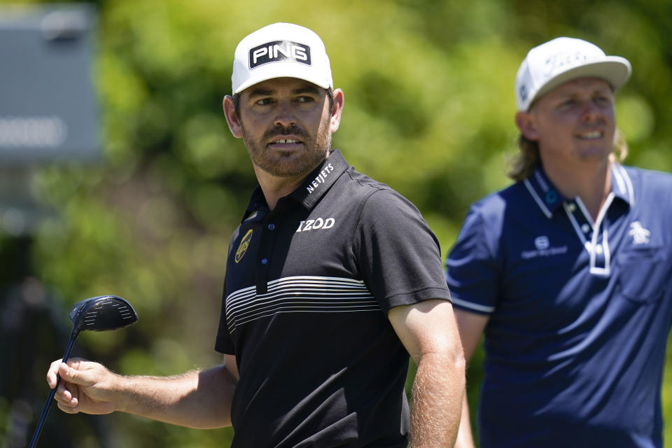 Louis Oosthuizen, of South Africa, left, watches his shot off the second tee during the final round of the PGA Zurich Classic golf tournament at TPC Louisiana in Avondale, La., Sunday, April 25, 2021. (AP Photo/Gerald Herbert)