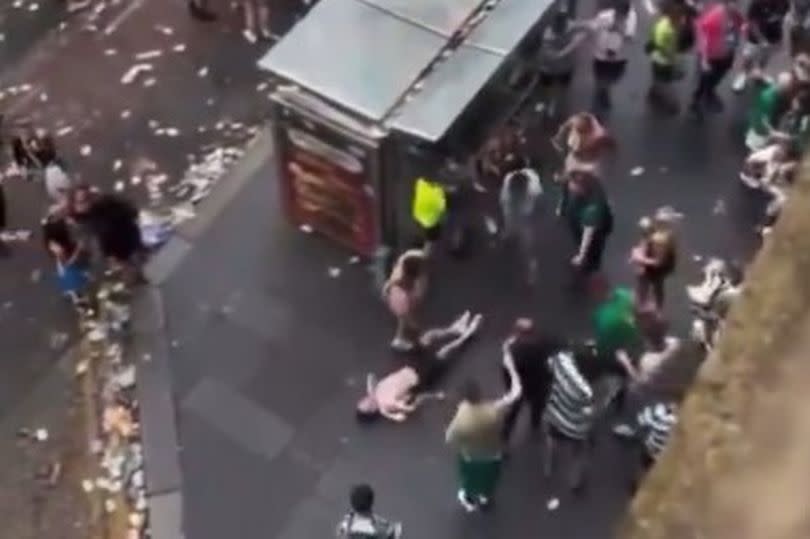 The man appears to be unconscious as he lies on the pavement in the Trongate.