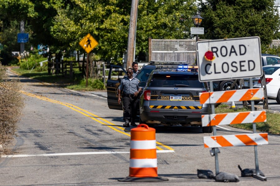 Pennsylvania State Police Officers walk on a blocked off road as the search continues for the escaped inmate Danelo Cavalcante in Chadds Ford, Pa., on Wednesday, Sept. 6, 2023. (Tyger Williams/The Philadelphia Inquirer via AP)