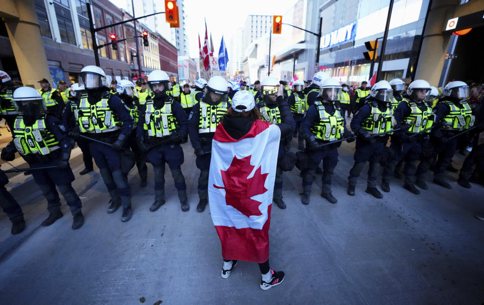 A protester confronts police during a demonstration, part of a convoy-style protest participants are calling "Rolling Thunder", Friday, April 29, 2022, in Ottawa. (Sean Kilpatrick/The Canadian Press via AP)