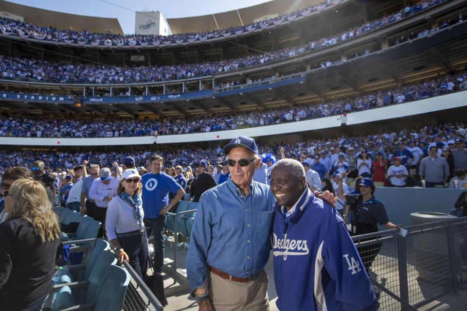 Former Dodgers pitcher Sandy Koufax, left, and former Dodgers outfielder Lou Johnson pose for a photo.