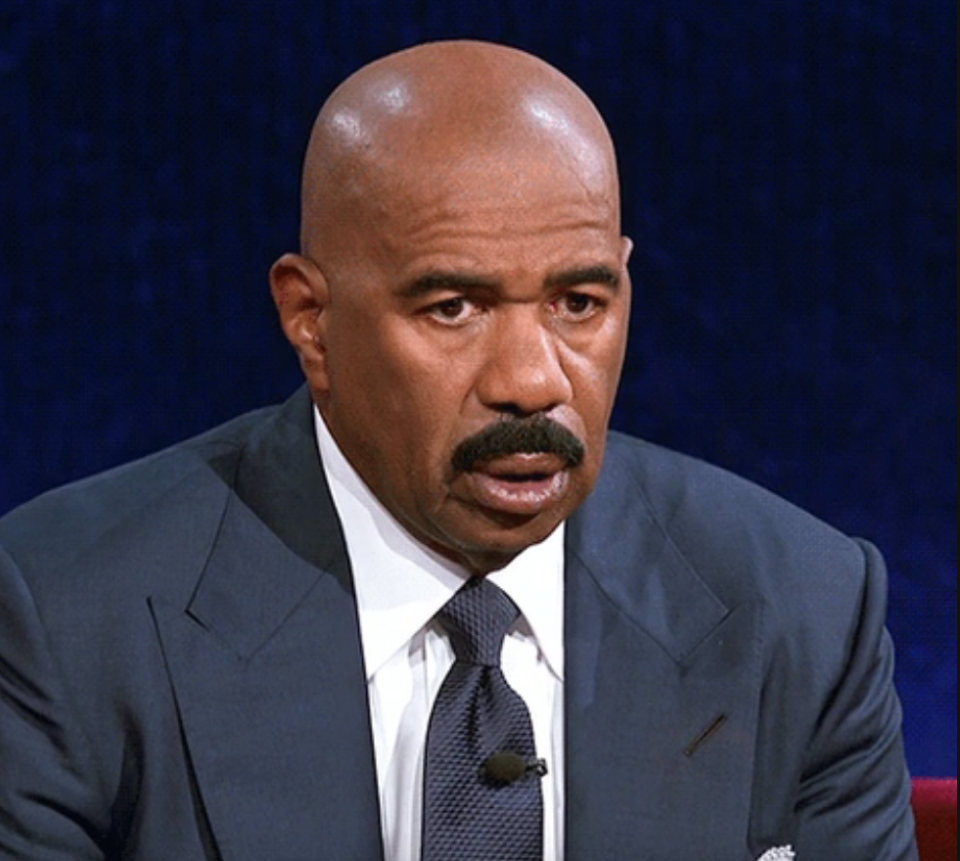 Steve Harvey in a suit looking stunned