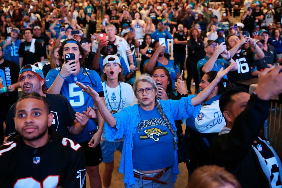 Lisa Miller, center, reacts to the 27th pick, Anton Harrison, during an NFL Draft watch party Thursday, April 27, 2023 at TIAA Bank Field’s Daily’s Place in Jacksonville, Fla. The Jacksonville Jaguars selected, with the 27th pick, offensive tackle Anton Harrison from Oklahoma. 