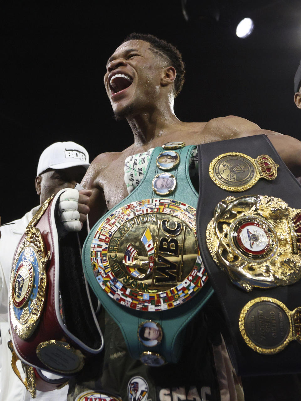 United States' Devin Haney displays his belts after defeating George Kambosos Jr. of Australia as Haney defends his undisputed lightweight boxing title in Melbourne, Sunday, Oct. 16, 2022. (AP Photo/Hamish Blair)
