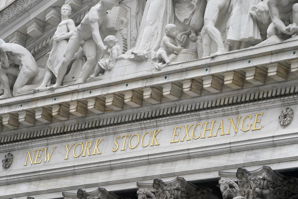 FILE - In this Nov. 23, 2020 file photo, stone sculptures adorn the New York Stock Exchange. Stocks are easing lower in early trading on Wall Street as investors absorb the latest round of company earnings reports. The S&P 500 was off 0.2% in the first few minutes of trading Tuesday, April 20, 2021, pulling further below the record high it set on Friday. (AP Photo/Seth Wenig, File)