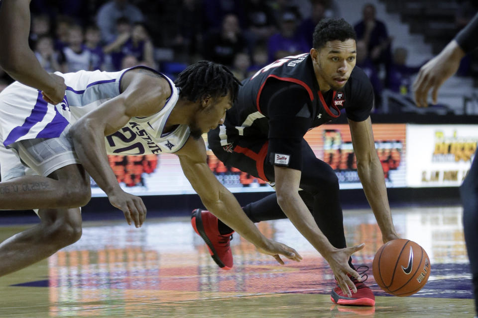 Texas Tech forward TJ Holyfield, right, beats Kansas State forward Xavier Sneed (20) to a loose ball during the first half of an NCAA college basketball game in Manhattan, Kan., Tuesday, Jan. 14, 2020. (AP Photo/Orlin Wagner)