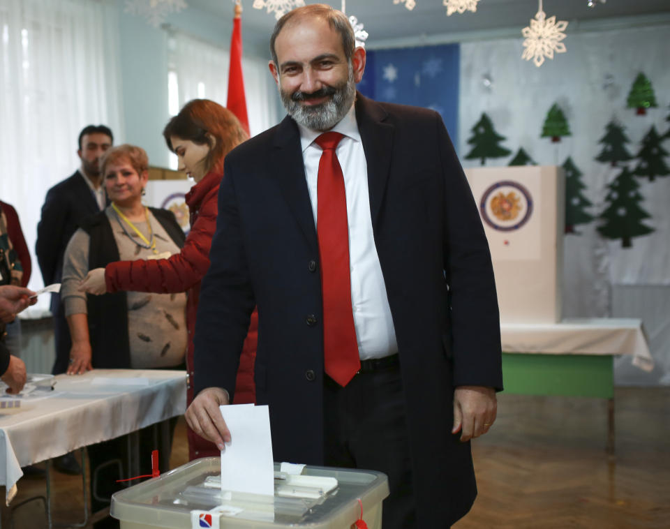 Acting Armenian Prime Minister Nikol Pashinian casts his ballot in a polling station during an early parliamentary election in Yerevan, Armenia, Sunday, Dec. 9, 2018. The charismatic 43-year-old Nikol Pashinian took office in May after spearheading massive protests against his predecessor's power grab that forced the politician to step down. (Vahan Stepanyan/PAN Photo via AP)