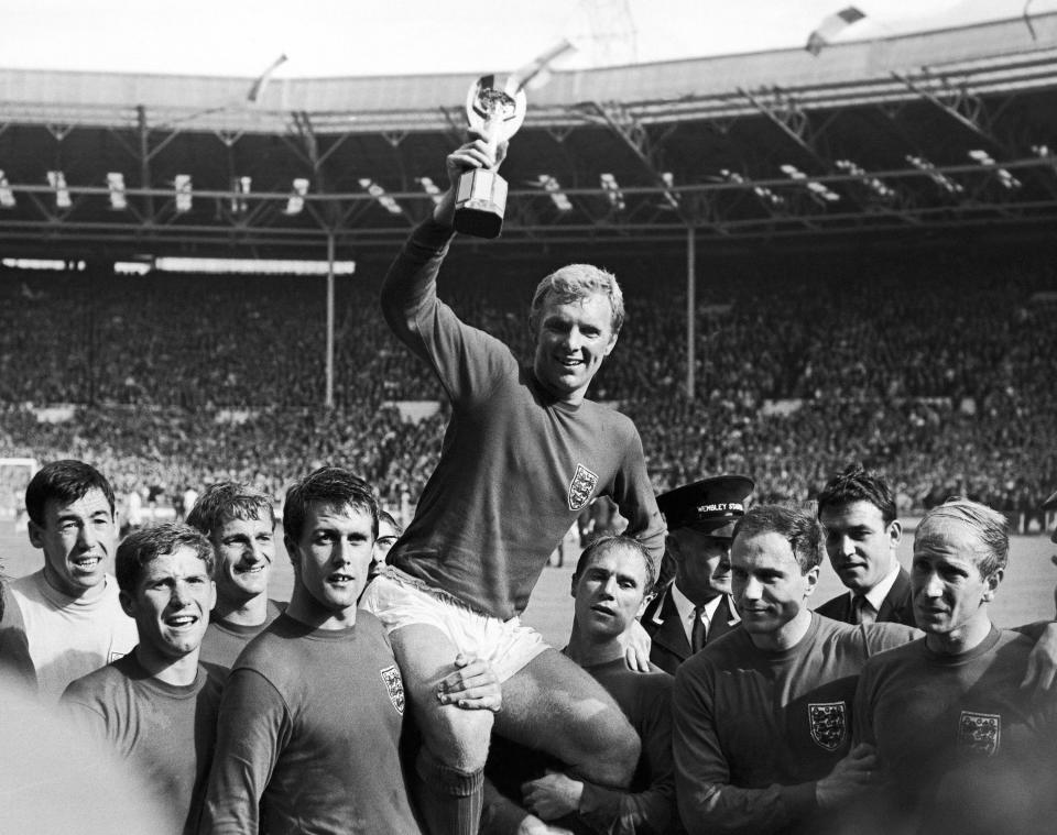 FILE - In this July 30, 1966 file photo, England's soccer team captain Bobby Moore, carried shoulder high by his teammates, holds aloft the Jules Rimet World Cup. England defeated West Germany 4-2 in the final, played at London's Wembley Stadium. From left to right, goalkeeper Gordon Banks, Alan Ball, Martin Peters, Geoff Hurst, Moore, Ray Wilson, George Cohen and Bobby Charlton. Peters, who scored one of England's goals in its victory over West Germany in the 1966 World Cup final, has died after a long battle with Alzheimer's disease. He was 76. Peters' family announced his death on Saturday,