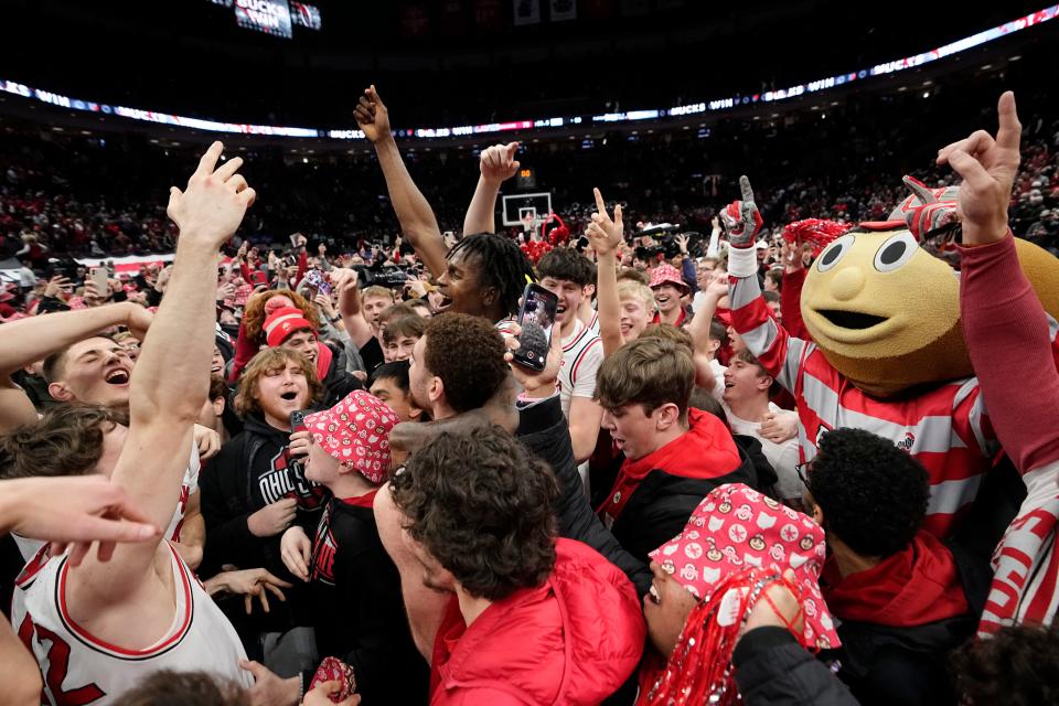 Feb 18, 2024; Columbus, Ohio, USA; Fans storm the court as the Ohio State Buckeyes celebrate following their 73-69 win over Purdue Boilermakers in the NCAA men’s basketball game at Value City Arena.