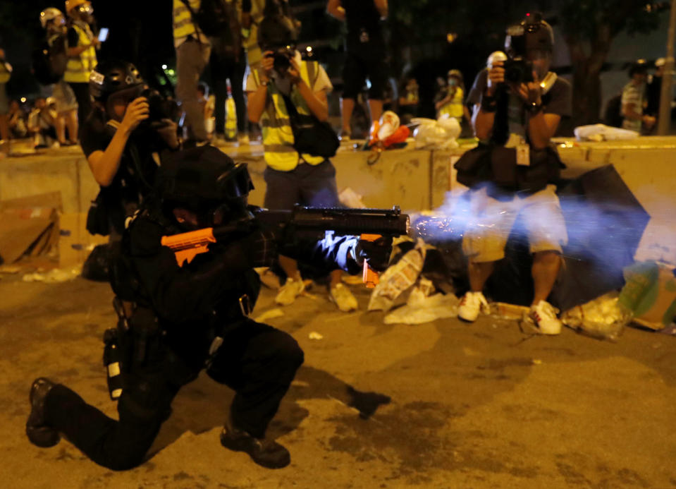 A police officer fires a baton round outside the Legislative Council building, after protesters stormed the building on the anniversary of Hong Kong's handover to China in Hong Kong, China July 1, 2019. (Photo: Tyrone Siu/Reuters)