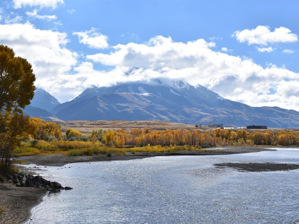 FILE - In this Oct. 8, 2018 file photo, emigrant Peak is seen rising above the Paradise Valley and the Yellowstone River near Emigrant, Mont. Lawmakers have reached bipartisan agreement on an election-year deal to double spending on a popular conservation program and devote nearly $2 billion a year to improve and maintain national parks. (AP Photo/Matthew Brown, File)