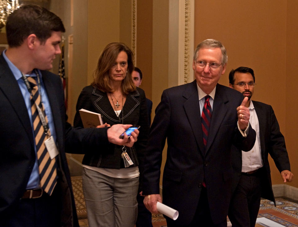 McConnell gives the the thumbs-up as he walks to the Senate floor after a deal was reached to avert a US default at the Capitol in Washington July 31, 2011. (NICHOLAS KAMM/AFP/Getty Images)