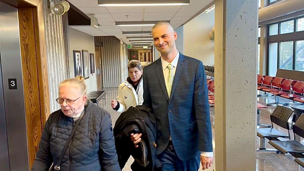 Chris Enns is shown on Monday with two supporters at Nova Scotia Supreme Court in Halifax. (Richard Cuthbertson/CBC - image credit)