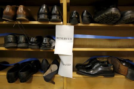 Shoes removed by visitors out of reverence sit on a shelf marked "reserved" prior to remarks by U.S. President Barack Obama at the Islamic Society of Baltimore mosque in Catonsville, Maryland February 3, 2016. REUTERS/Jonathan Ernst