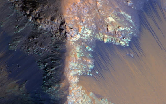 Recurring slope lineae on Mars, such as these dark streaks shown in Coprates Chasma, are possibly caused by seeping water.