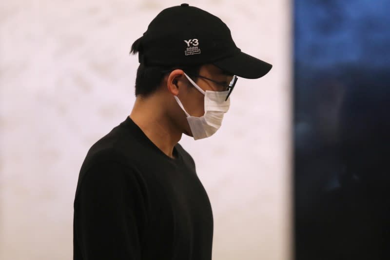 Japanese badminton player Kento Momota arrives at Kuala Lumpur International Airport, as he leaves for Tokyo, after he was released from hospital following an injury in a vehicle collision on Monday, in Sepang