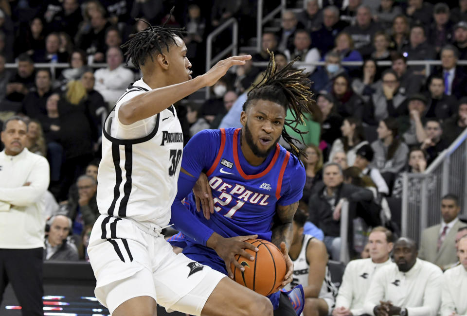 DePaul's Da'Sean Nelson (21) is blocked by Providence's Rafael Castro (30) during the first half of an NCAA college basketball game, Saturday, Jan. 21, 2023, in Providence, R.I. (AP Photo/Mark Stockwell)