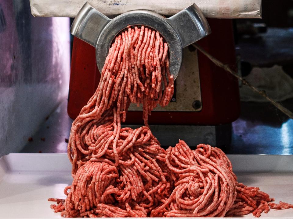 Beef going through a meat grinder