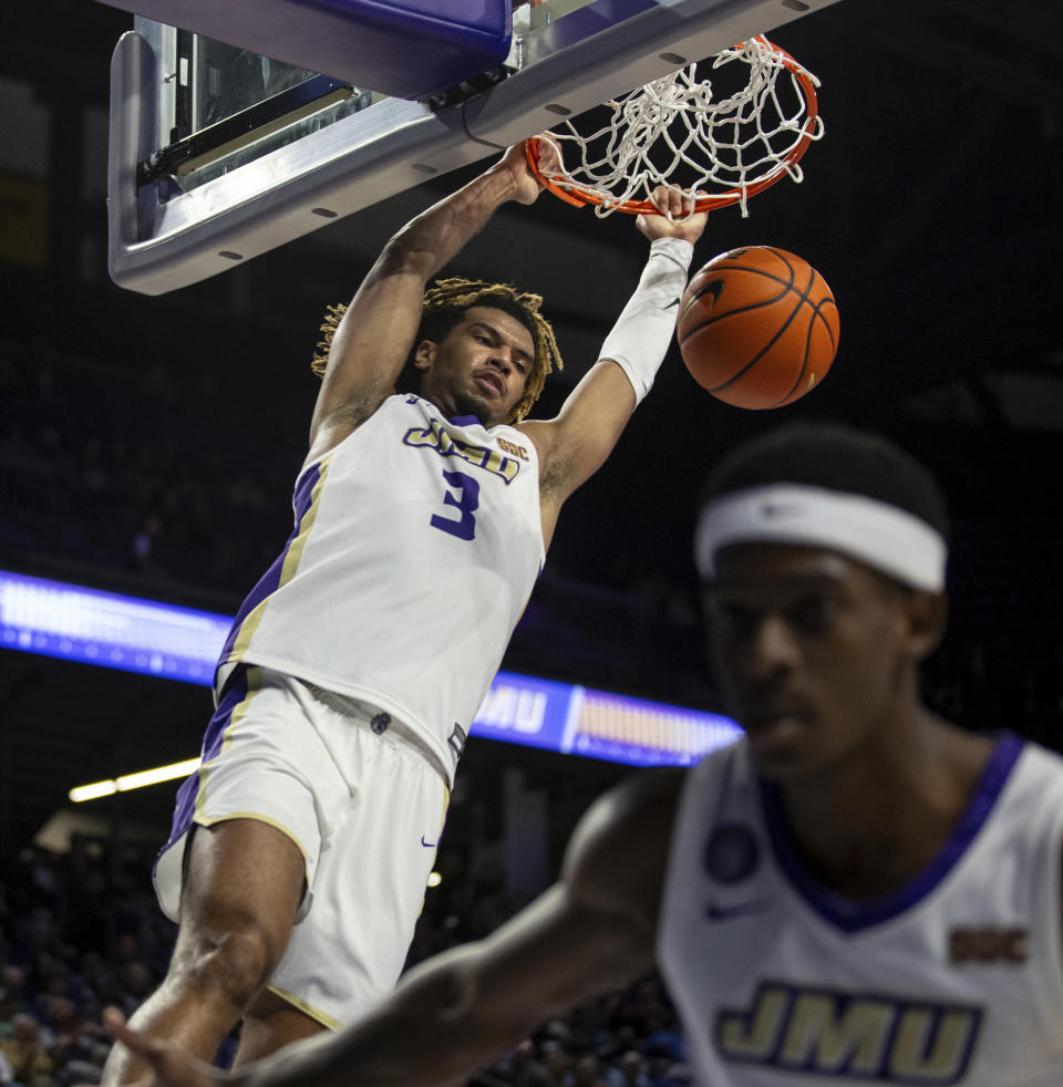 James Madison forward T.J. Bickerstaff (3) dunks the ball during the first half of an NCAA college basketball game against Buffalo in Harrisonburg, Va., Wednesday, Nov. 29, 2023. (Daniel Lin/Daily News-Record via AP)