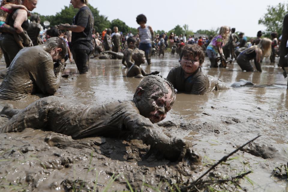 Christian Kubanek, 4 of Lincoln Park plays in the mud during Mud Day at the Nankin Mills Park, Tuesday, July 9, 2019, in Westland, Mich. The annual day sponsored by the Wayne County Parks takes place in a 75' x 150' giant mud pit that gives children the opportunity to get down and dirty at one of the messiest playgrounds Southeast Michigan has ever seen. (AP Photo/Carlos Osorio)