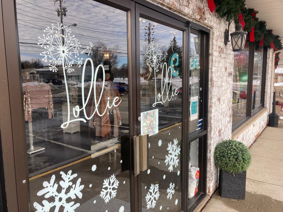 The doors and exterior wall are decorated for the holiday season at Lollie & Co. in the Shops at the Colony on West Eighth Street.