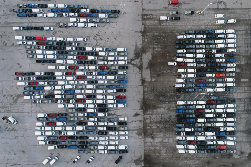 FILE - In this Wednesday, March 24, 2021 file photo, mid-sized pickup trucks and full-size vans are seen in a parking lot outside a General Motors assembly plant where they are produced in Wentzville, Mo. General Motors says efforts to manage the global computer chip shortage have worked better than expected, so it’s financial results will improve over previous forecasts. The company says in a statement Thursday, June 3, it has made engineering changes, prioritized semiconductor use and pulled some potential deliveries into the second quarter. (AP Photo/Jeff Roberson, File)