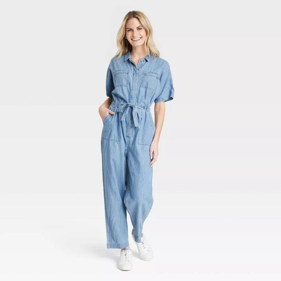 model wearing blue short sleeve utility-inspired jumpsuit