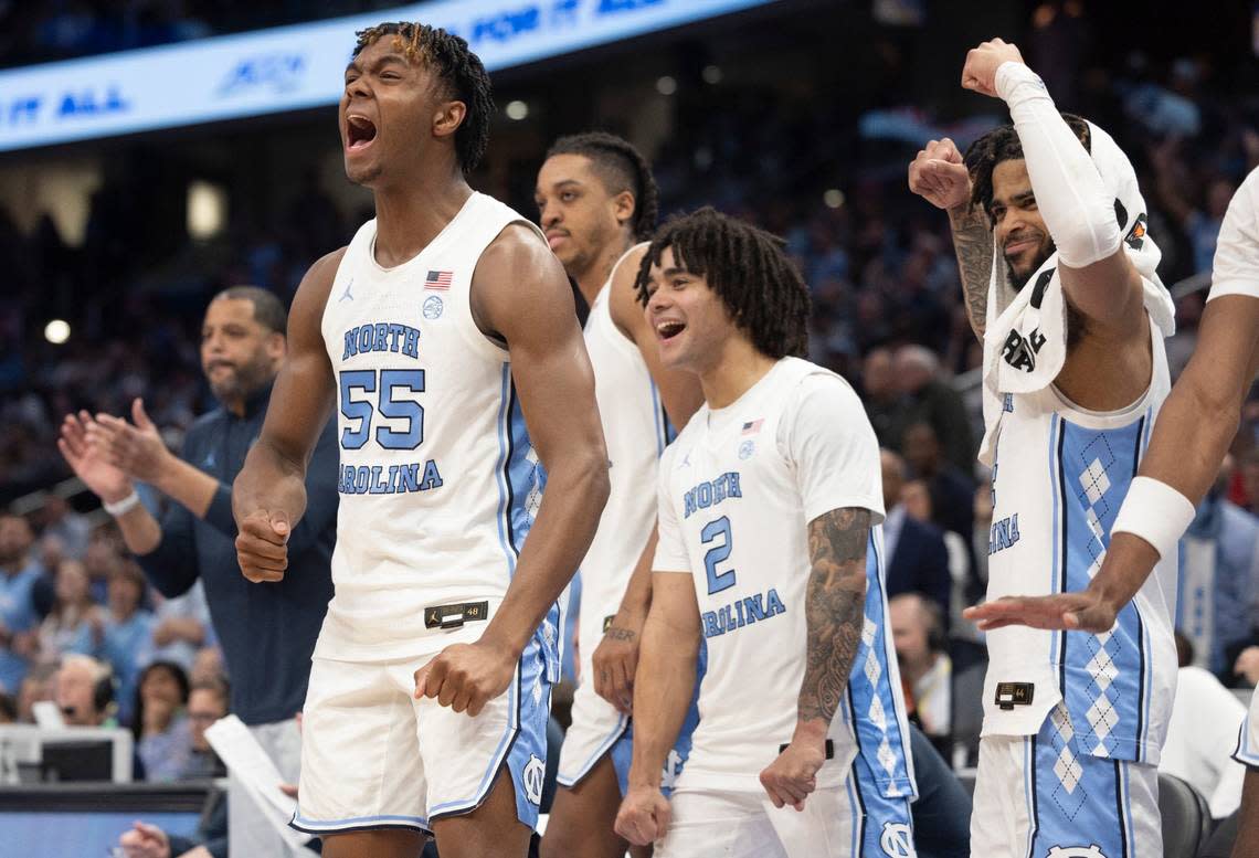 North Carolina’s Harrison Ingram (55), Elliot Cadeau (2) and R.J. Davis (4) celebrate on the bench in the closing minute of play as reserve player Zayden High (1) scores against Florida State in the quarterfinals of the ACC Men’s Basketball Tournament at Capitol One Arena on Wednesday, March 13, 2024 in Washington, D.C.