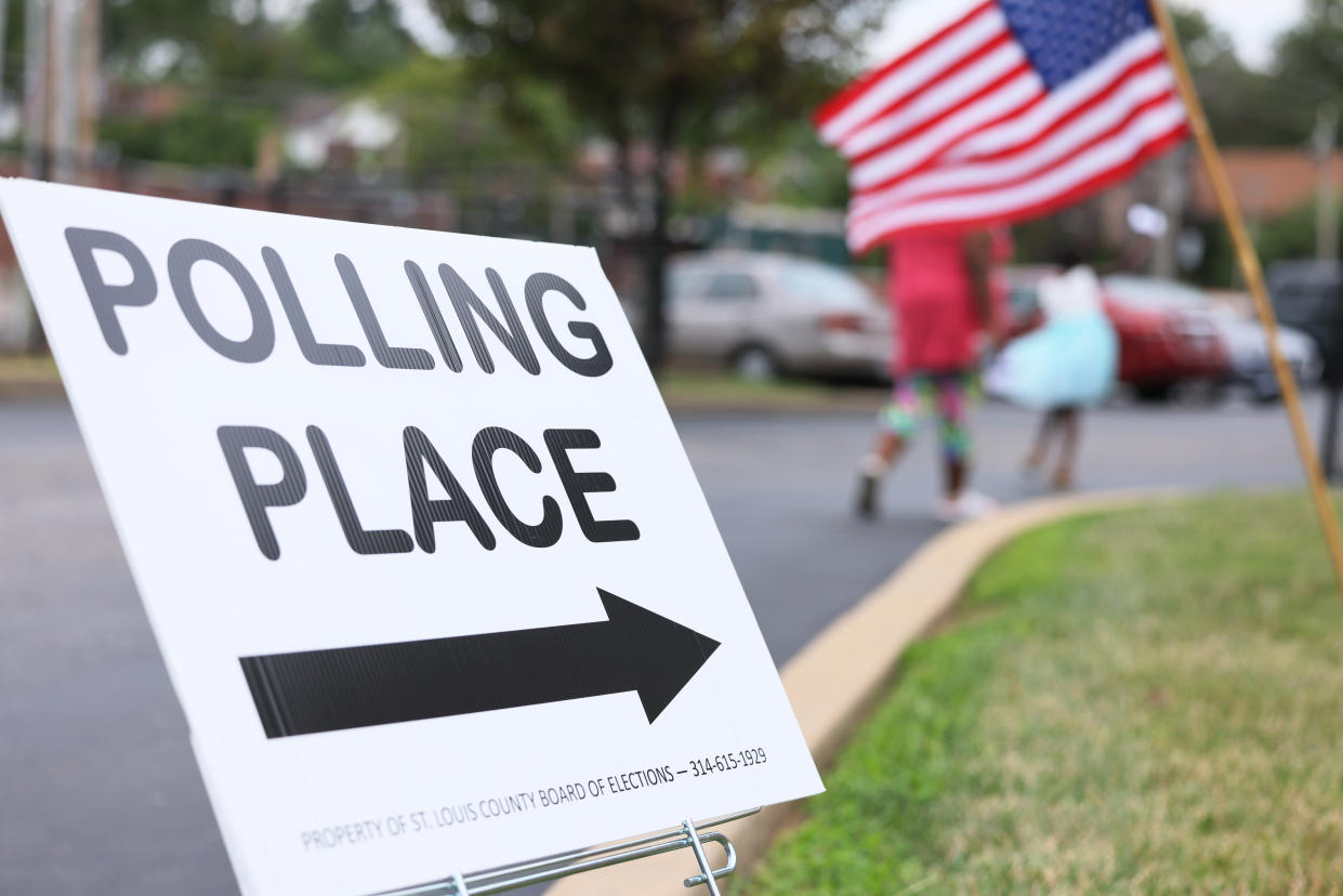 A sign next to a parking lot reads: Polling place.