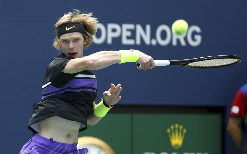 Andrey Rublev, of Russia, returns a shot to Stefanos Tsitsipas, of Greece, during the first round of the US Open tennis tournament Tuesday, Aug. 27, 2019, in New York. (AP Photo/Kevin Hagen)