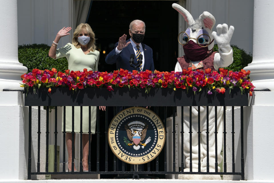FILE - In this Monday, April 5, 2021 file photo, President Joe Biden and first lady Jill Biden wave from the Blue Room balcony as they participate in an Easter event at the White House in Washington. The annual East Egg Roll at the White House was canceled due to the ongoing pandemic. On Friday, April 9, 2021, The Associated Press reported on stories circulating online incorrectly asserting Biden needed a special medical team at the White House and was taken to the hospital late Sunday. But Biden was not at the White House on Easter Sunday; he celebrated the holiday at Camp David. Biden returned to Washington via Marine One around noon on Monday, according to reporting by The Associated Press. (AP Photo/Evan Vucci)