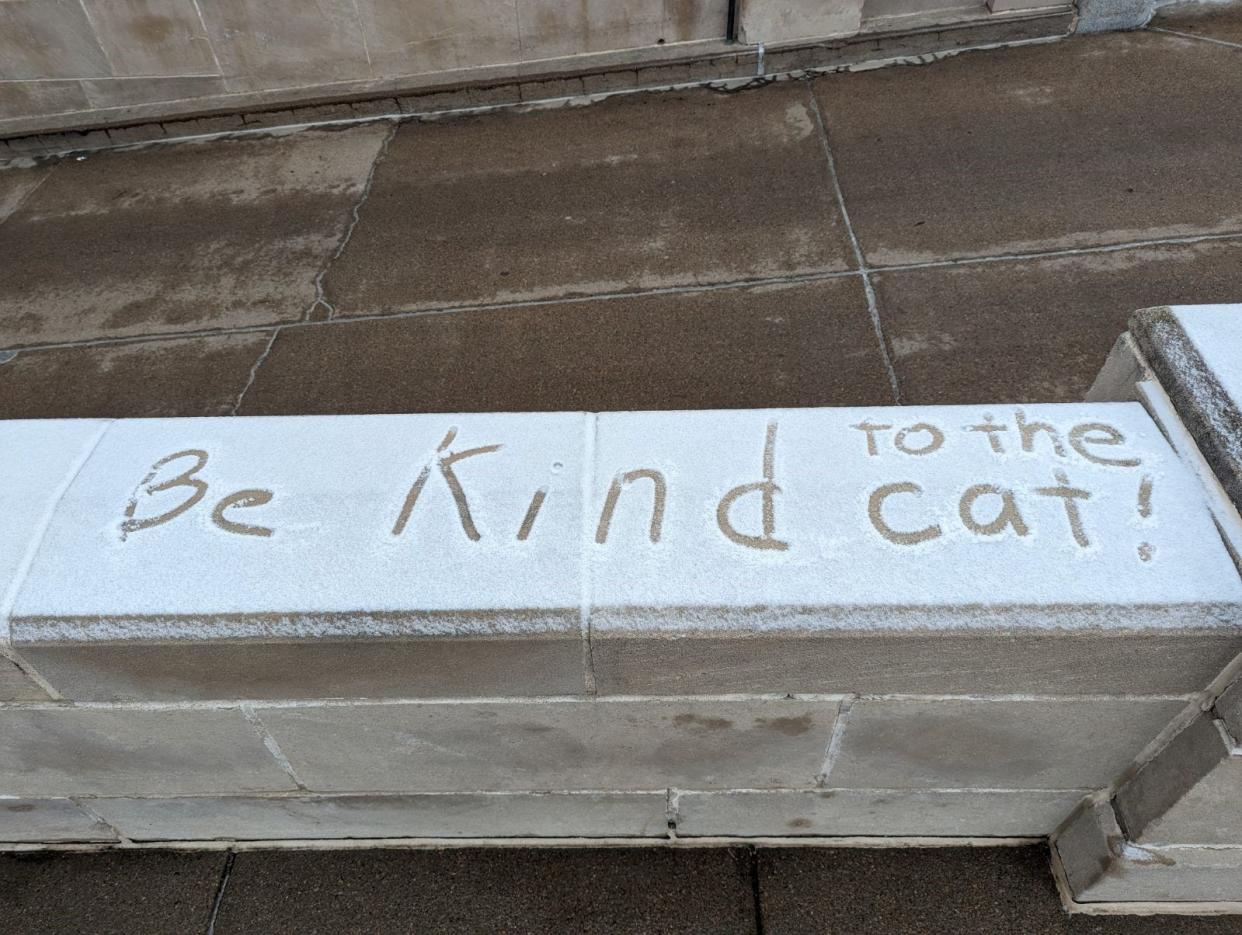 Nebraska Capitol visitors write messages about Cameron in the snow.