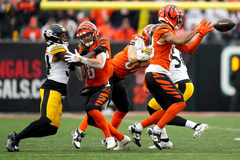 Cincinnati Bengals wide receiver Tyler Boyd (83) catches a pass as Cincinnati Bengals wide receiver Trenton Irwin (16) blocks in the fourth quarter of a Week 12 NFL football game between the Pittsburgh Steelers and the Cincinnati Bengals, Sunday, Nov. 26, 2023, at Paycor Stadium.