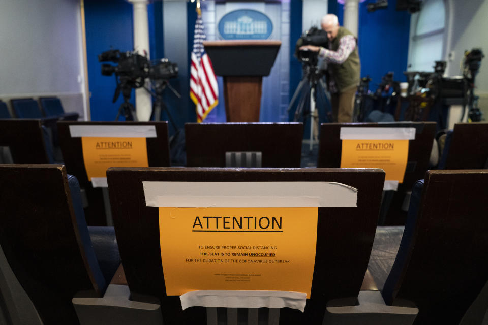 Signs in the briefing room of the White House indicate social distancing measures being taken to separate reporters working at the White House, Monday, March 16, 2020, in Washington. (AP Photo/Evan Vucci)