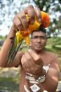 A lorikeet with a ring on its leg as proof of its breeding program birth at a vast aviary in Bogor, south of Jakarta, pictured at the aviary on January 6, 2015