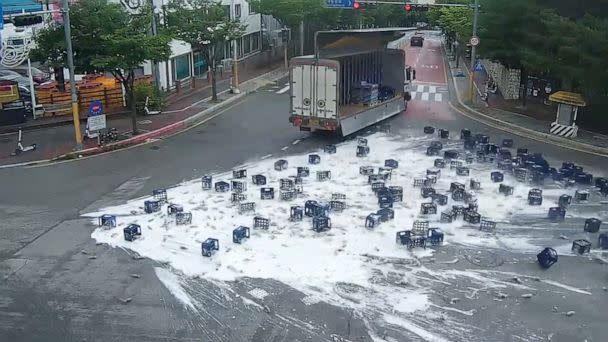 PHOTO: Bottles of beer fall off a truck as the driver makes a sharp turn in Chuncheon, South Korea, June 29, 2022. (KBS)