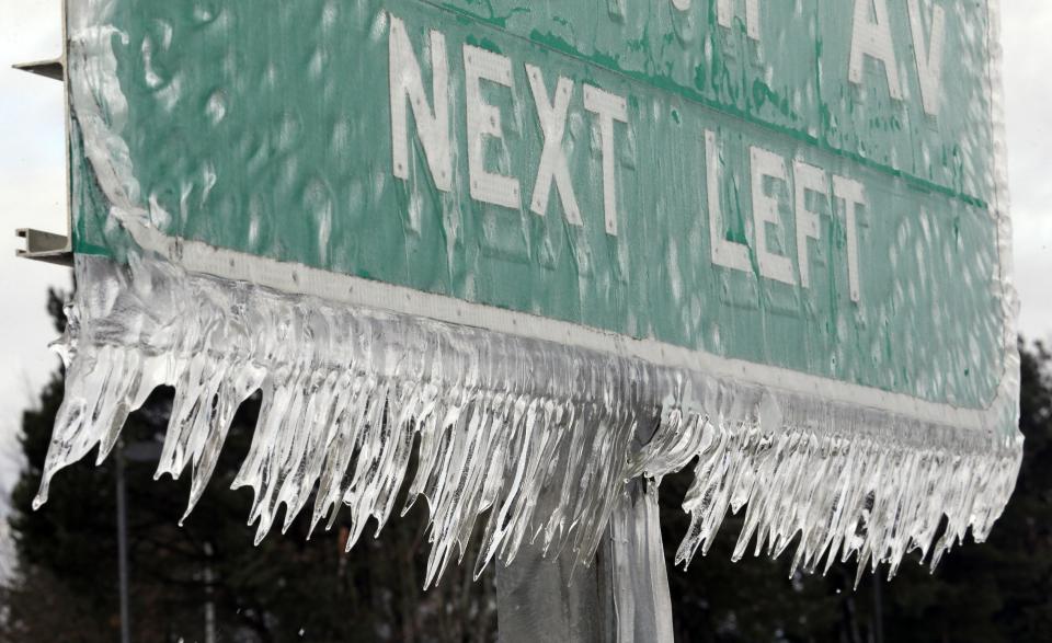 Icicles, formed by freezing rain and stiff winds, hang from a road sign along Interstate 84 in Troutdale, Ore., Wednesday, Jan. 18, 2017. An ice storm shut down parts of major highways and interstates Wednesday in Oregon and Washington state and paralyzed the hardest hit towns along the Columbia River Gorge with up to 2 inches of ice coating the ground in some places. (AP Photo/Don Ryan)