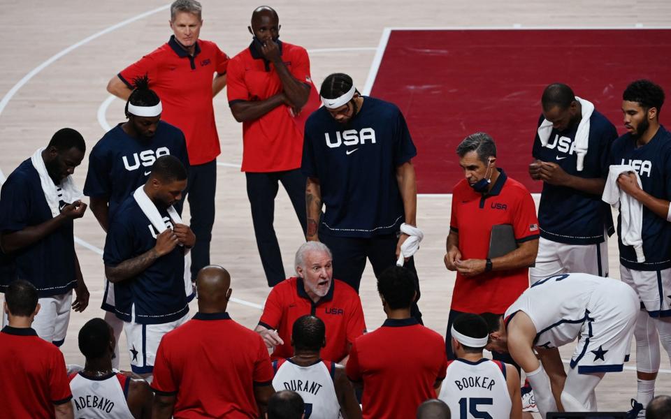 USA's coach Gregg Popovich (C) speaks to his players during a time out in the men's final basketball match between France and USA during the Tokyo 2020 Olympic Games at the Saitama Super Arena in Saitama on August 7, 2021. - Mohd RASFAN / AFP