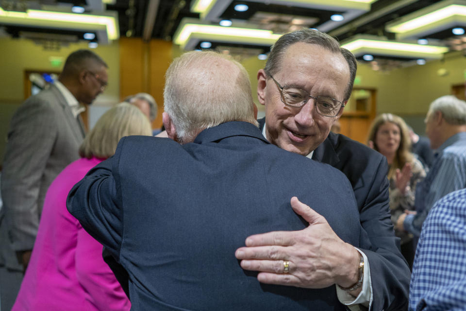 Jeff Iorg, right, hugs presidential search team chair Neal Hughes, Thursday, March 21, 2024, in Dallas, Texas, after Iorg was named the next president and CEO of the Southern Baptist Convention's Executive Committee. (Adam Covington/Baptist Press via AP)