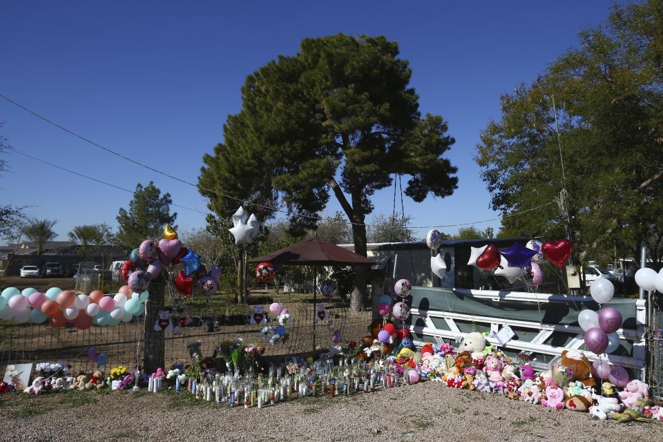 A makeshift memorial grows in front of the home where 22-year-old Rachel Henry was arrested on suspicion of killing her three children after they were found dead inside the family home earlier in the week, shown here Thursday, Jan. 23, 2020, in Phoenix. (AP Photo/Ross D. Franklin)