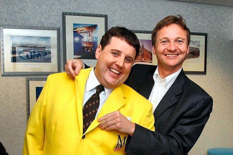 Peter Kay in a stewards jacket with John Knight from the MEN Arena -Credit:EMMA WILLIAMS