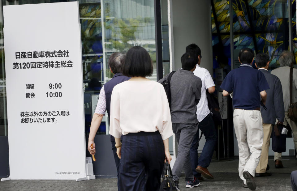 Shareholders enter a conference hall to attend Nissan's general meeting of shareholders in Yokohama, near Tokyo, Tuesday, June 25, 2019. Japanese automaker Nissan faces shareholders as profits and sales tumble after its former star chairman faces trial on financial misconduct allegations. (AP Photo/Koji Sasahara)