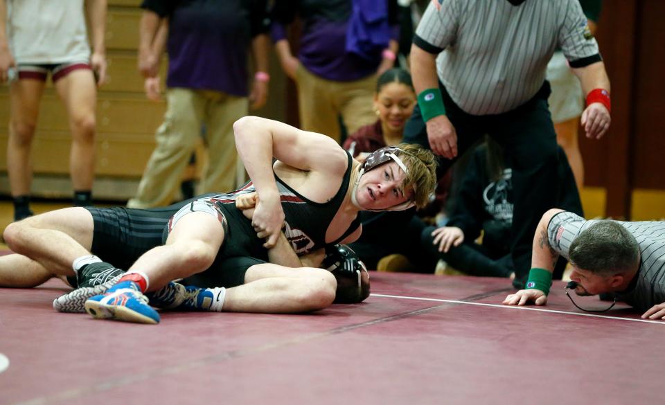 Mishawaka senior Beau Brabender looks toward the clock while controlling his opponent, Warren Central's Anthony Cashman, during a semifinal contest in the 157-pound weight class at the Al Smith Classic Wrestling Invitational Saturday, Dec. 30, 2023, at Mishawaka High School.