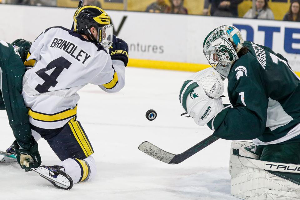 Michigan State goaltender Trey Augustine makes a save against Michigan right wing Gavin Brindley during the third period at Yost Ice Arena in Ann Arbor on Friday, Feb. 9, 2024.