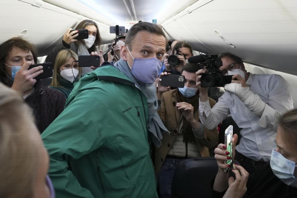 FILE - Opposition leader Alexei Navalny is surrounded by journalists before taking off from Berlin to fly home to Moscow, Jan. 17, 2021. Navalny was arrested upon landing in Moscow and was later convicted on several charges and sentenced to 19 years in prison. He died in prison in February 2024. (AP Photo/Mstyslav Chernov, File)