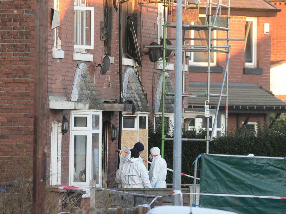 Forensic officers at the scene of the house fire on Jackson Street in Worsley, Greater Manchester (PA)